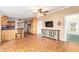 Inviting living space featuring wood floors, kitchen access and a charming, eclectic TV stand at 17913 E Watford Dr, Queen Creek, AZ 85142