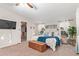 Well-lit main bedroom with ceiling fan, carpet, ample windows, and a view into the ensuite closet at 17913 E Watford Dr, Queen Creek, AZ 85142