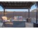 Comfortable outdoor patio with a fire pit table and ample seating, perfect for relaxing evenings at 17913 E Watford Dr, Queen Creek, AZ 85142