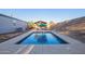 Backyard pool with concrete trim, wooden gazebo, and privacy fence; perfect for outdoor relaxation at 17913 E Watford Dr, Queen Creek, AZ 85142
