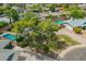 Aerial view of a well-maintained home featuring a pool, mature trees, and a circular driveway at 1817 W Seldon Ln, Phoenix, AZ 85021