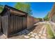 Fenced backyard with wood shed and stone walkway at 1817 W Seldon Ln, Phoenix, AZ 85021