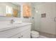 Modern bathroom featuring white vanity, subway tile shower with glass door and storage at 1817 W Seldon Ln, Phoenix, AZ 85021