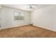 A comfortable bedroom with a ceiling fan and a window at 1817 W Seldon Ln, Phoenix, AZ 85021