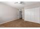 Neutral bedroom featuring a ceiling fan, carpet flooring, and a closet with double doors at 1817 W Seldon Ln, Phoenix, AZ 85021