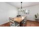 Bright dining room features rustic wood table, modern chandelier and ample natural light at 1817 W Seldon Ln, Phoenix, AZ 85021