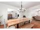 Open dining room with chandelier, rustic table set and easy access to additional rooms at 1817 W Seldon Ln, Phoenix, AZ 85021