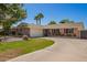 Attractive home boasts a wide driveway, lush lawn, and colorful flowers enhancing its curb appeal at 1817 W Seldon Ln, Phoenix, AZ 85021