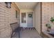 Cozy front porch featuring a bench, decorative wreath, and well-maintained brickwork, creating a welcoming entrance at 1817 W Seldon Ln, Phoenix, AZ 85021