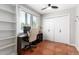 Bright home office with desk, shelves, large window, and closet offers a dedicated workspace at 1817 W Seldon Ln, Phoenix, AZ 85021