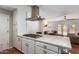 Bright kitchen featuring modern range hood, kitchen island, and easy access to adjacent living area at 1817 W Seldon Ln, Phoenix, AZ 85021