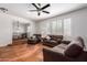 Inviting living room with comfortable sofas, a ceiling fan, and ample natural light, creating a relaxing atmosphere at 1817 W Seldon Ln, Phoenix, AZ 85021