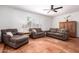 Bright living room showcasing neutral sofas, plantation shutters, and decorative cabinet at 1817 W Seldon Ln, Phoenix, AZ 85021