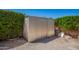 Metal shed surrounded by gravel and greenery, perfect for storage in a convenient backyard setting at 1817 W Seldon Ln, Phoenix, AZ 85021
