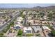 Overhead shot of a residential area, highlighting solar panels, pools, and tree-lined streets with mountain views at 18562 N Alamo Dr, Surprise, AZ 85374