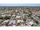 Aerial view of neighborhood with houses, pools, and a view of distant mountains at 18562 N Alamo Dr, Surprise, AZ 85374