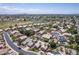 Scenic aerial view showcasing a neighborhood near a golf course, boasting well-maintained homes and mature trees at 18562 N Alamo Dr, Surprise, AZ 85374