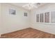 A light and airy bedroom features hardwood floors, plantation shutters, and an overhead ceiling fan at 18562 N Alamo Dr, Surprise, AZ 85374