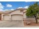 Attractive single-Gathering home with a 3-car garage and a beautifully landscaped front yard at 18562 N Alamo Dr, Surprise, AZ 85374