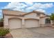 Spacious three-car garage with neutral-colored doors at 18562 N Alamo Dr, Surprise, AZ 85374