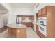 Bright kitchen features ample cabinet space, stainless steel appliances, and a large center island at 18562 N Alamo Dr, Surprise, AZ 85374
