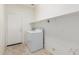 Functional laundry room with washer, dryer, and storage shelf at 18562 N Alamo Dr, Surprise, AZ 85374