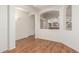 Spacious living area with arched doorway, wood-look floors, and a seamless transition to the kitchen at 18562 N Alamo Dr, Surprise, AZ 85374