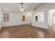 Spacious open-concept living room with archways, ceiling fans, and wood-look flooring at 18562 N Alamo Dr, Surprise, AZ 85374