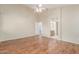Spacious main bedroom with wood floors, ceiling fan and adjacent bathroom at 18562 N Alamo Dr, Surprise, AZ 85374