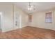 Large main bedroom featuring hardwood floors and open access to bathroom at 18562 N Alamo Dr, Surprise, AZ 85374