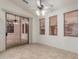 Bright sun room featuring tiled floor, ceiling fan, and sliding glass door to backyard at 18562 N Alamo Dr, Surprise, AZ 85374