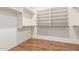 Walk-in closet features lots of shelving space and hardwood flooring at 18562 N Alamo Dr, Surprise, AZ 85374