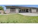 Well-maintained backyard featuring a covered patio and lush green grass at 18617 E Arrowhead Trl, Queen Creek, AZ 85142