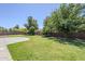 Landscaped backyard with green lawn and mature trees enhancing outdoor appeal at 18617 E Arrowhead Trl, Queen Creek, AZ 85142