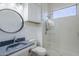 Updated bathroom featuring a gray granite sink, a round mirror and a glass shower at 18617 E Arrowhead Trl, Queen Creek, AZ 85142