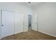 A carpeted bedroom has a closet and interior door at 18617 E Arrowhead Trl, Queen Creek, AZ 85142