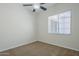 Cozy bedroom featuring soft carpet and large window for natural light at 18617 E Arrowhead Trl, Queen Creek, AZ 85142