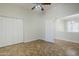 Bedroom with tile flooring, a ceiling fan with lights, and a closet at 18617 E Arrowhead Trl, Queen Creek, AZ 85142