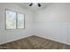 A carpeted bedroom features a fan, a window, and wainscoting on the lower walls at 18617 E Arrowhead Trl, Queen Creek, AZ 85142