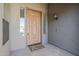 Charming front door with sidelights, an exterior light fixture, and a welcoming doormat at 18617 E Arrowhead Trl, Queen Creek, AZ 85142