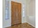 Charming front entryway showcasing a wooden door with sidelights, complemented by stylish floor tiling at 18617 E Arrowhead Trl, Queen Creek, AZ 85142