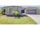 Charming front exterior featuring lush lawn, beautiful landscaping, and a well-manicured garden at 18617 E Arrowhead Trl, Queen Creek, AZ 85142