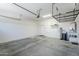 Spacious two car garage with water softener, storage racks and epoxy floor at 18617 E Arrowhead Trl, Queen Creek, AZ 85142