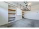 Two car garage featuring storage racks and built-in shelving at 18617 E Arrowhead Trl, Queen Creek, AZ 85142