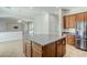Kitchen island with cabinets and drawers and view of the living room at 18617 E Arrowhead Trl, Queen Creek, AZ 85142