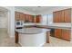Spacious kitchen featuring a center island, wood cabinets, and stainless steel appliances at 18617 E Arrowhead Trl, Queen Creek, AZ 85142