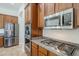Kitchen features stainless steel appliances including a microwave, oven, and refrigerator at 18617 E Arrowhead Trl, Queen Creek, AZ 85142