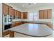 Spacious kitchen features stainless steel appliances, a central island, and ample cabinet storage at 18617 E Arrowhead Trl, Queen Creek, AZ 85142