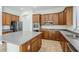 Modern kitchen featuring wood cabinets, stainless steel appliances, and center island at 18617 E Arrowhead Trl, Queen Creek, AZ 85142