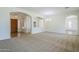 Bright living room with modern chandelier and archways, creating an inviting atmosphere at 18617 E Arrowhead Trl, Queen Creek, AZ 85142